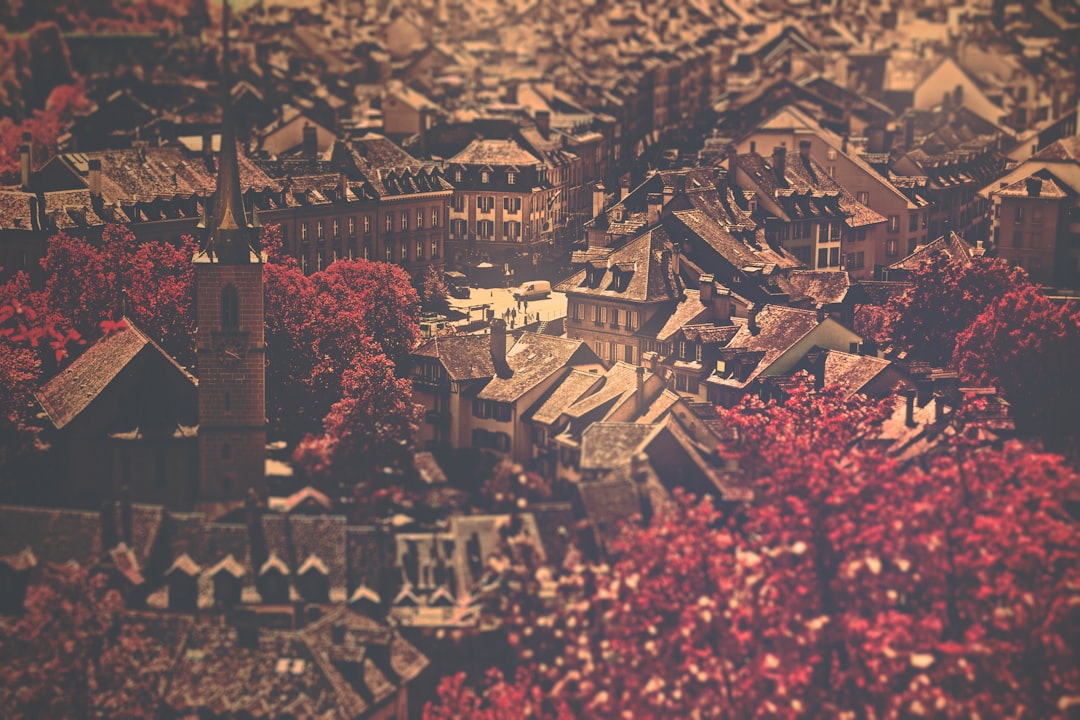 A close-up, detailed photograph of a vintage city map with certain neighborhoods outlined in red ink, illustrating the historical concept of redlining.
